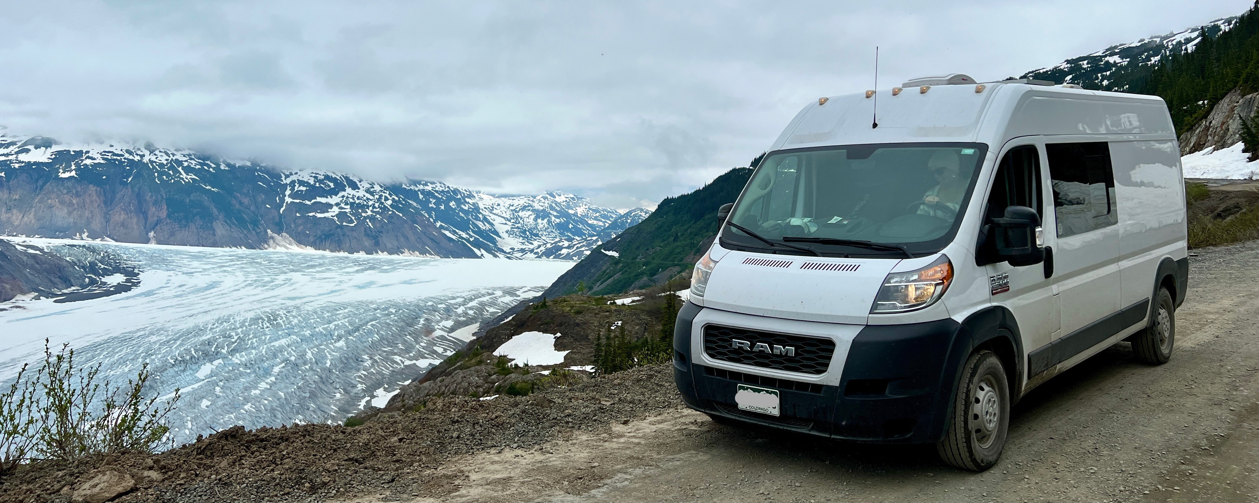 Mountain road winding through scenic wilderness perfect for camping road trips