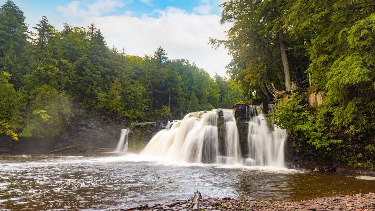 Manabezho Falls in Michigan Upper Peninsula surrounded by forest
